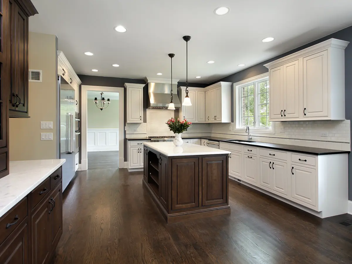 kitchen with dark hardwood floors and white kitchen cabinets