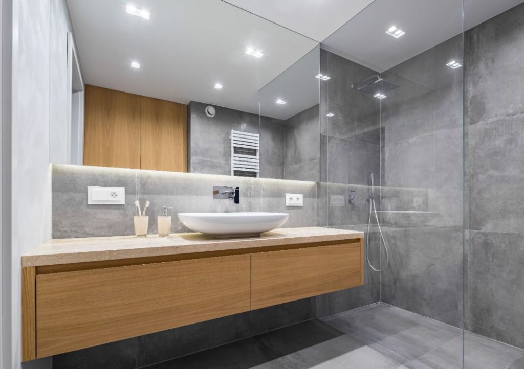 Gray stone bathroom with floating wood vanity