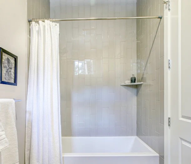 Older shower with curtain and rod