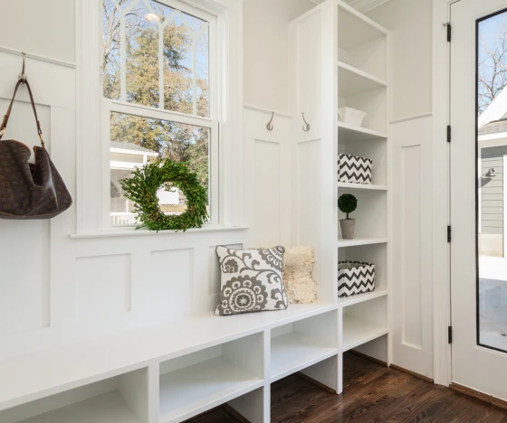 Entryway mudroom area with built-in shelving