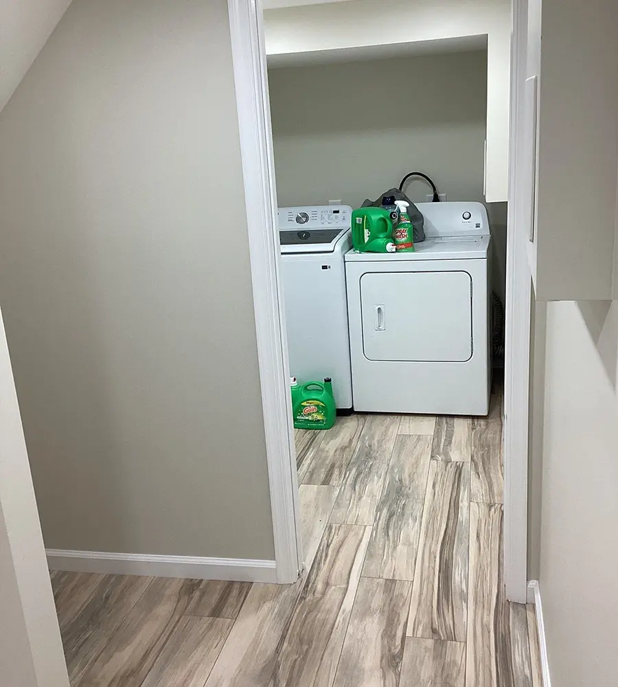 Laundry area with washer and dryer on wood-look tile flooring