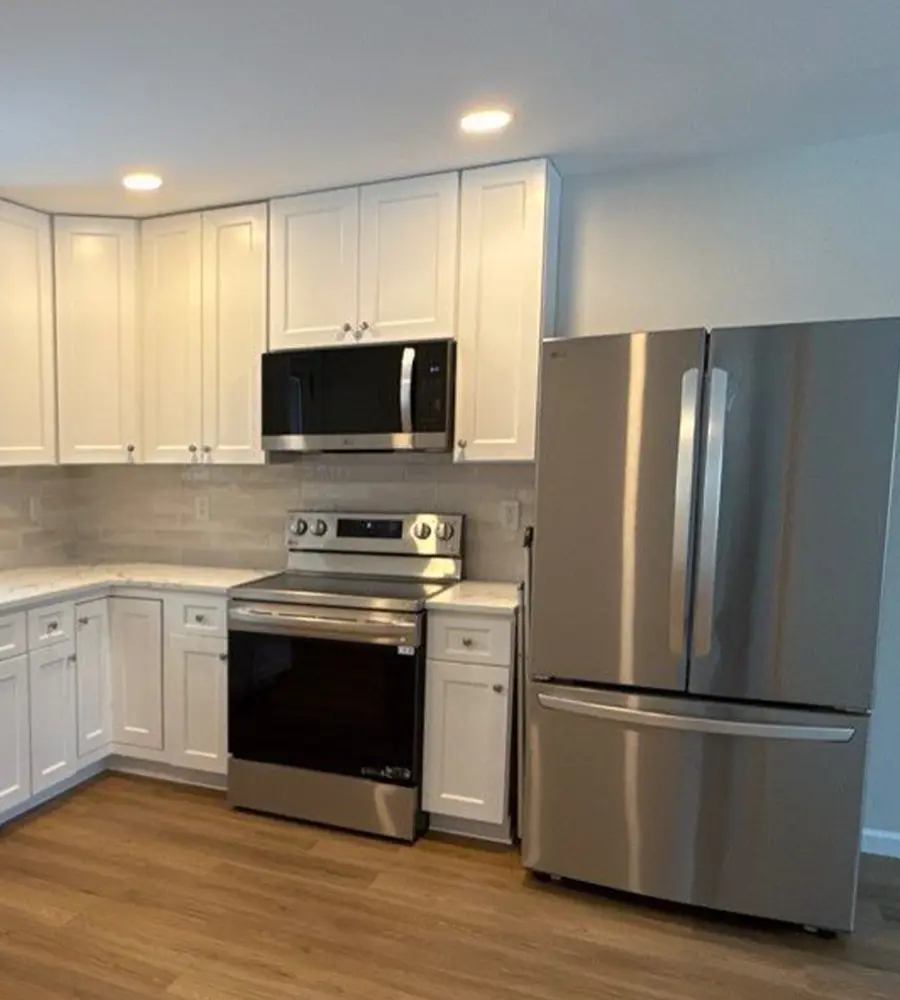 Modern kitchen with stainless steel appliances and white cabinetry