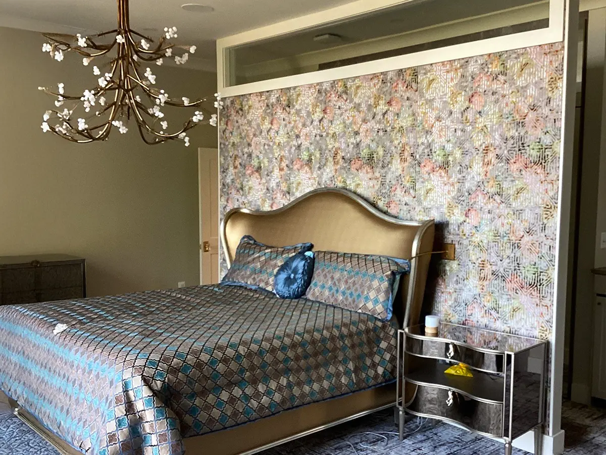Modern bedroom with upholstered headboard and floral accent wall