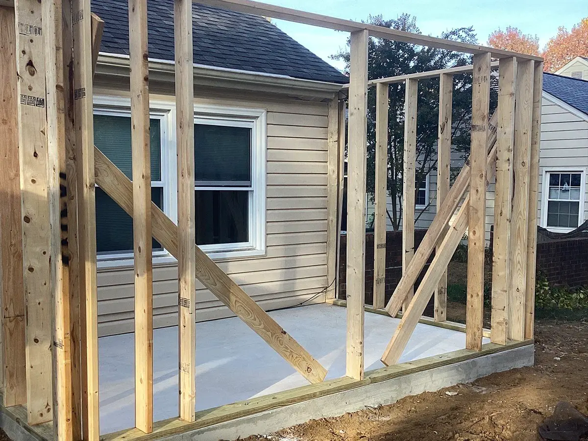 Framing structure underway for a small home extension on concrete foundation