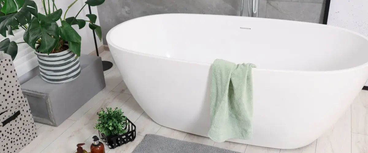 Hammered metal bathtub in elegant bathroom with large windows and natural light.