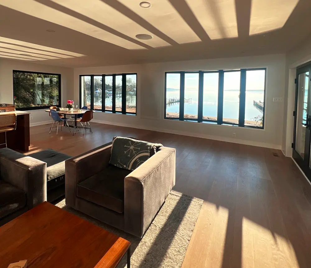 Open concept living and dining space with waterfront views