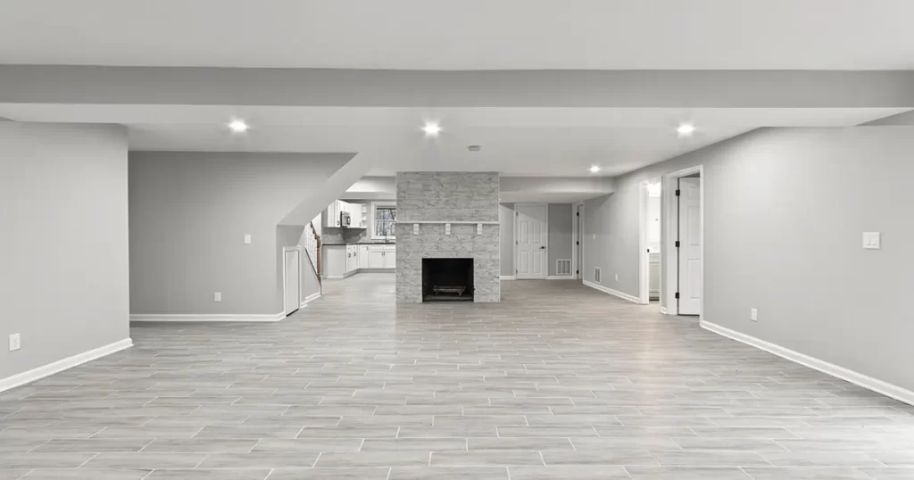 Finished basement with tile flooring and fireplace