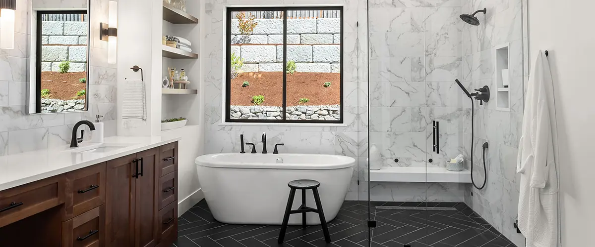 Marble bathroom with black fixtures and soaking tub
