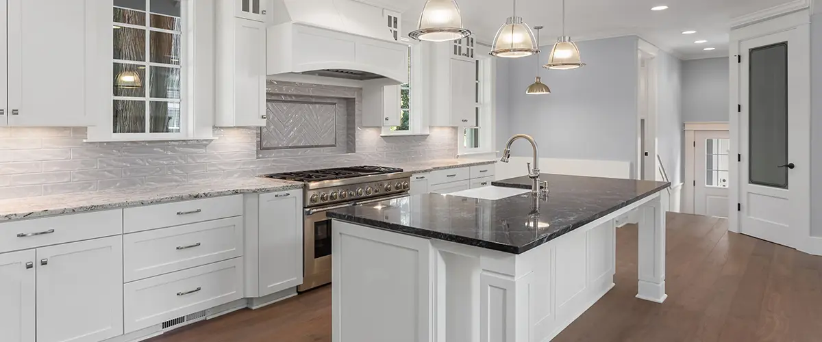 Elegant kitchen with black countertop and pendant lighting