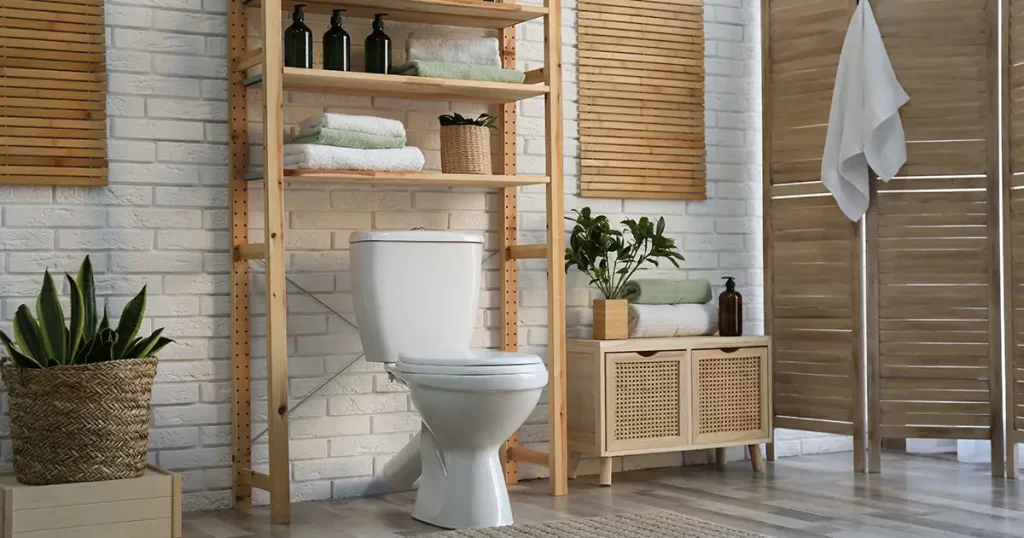Bathroom with natural wood shelving and white brick wall