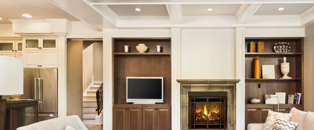 a basement living room featuring a coffered ceiling with recessed lighting