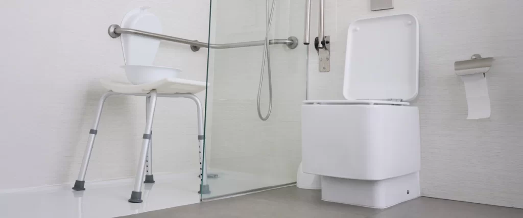 Modern bathroom accessibility for seniors featuring a height-adjustable shower stool, wall-mounted safety rails, and a barrier-free walk-in shower floor.