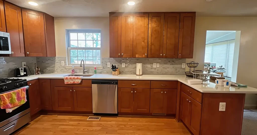 U-shaped kitchen layout with window sink and continuous countertop