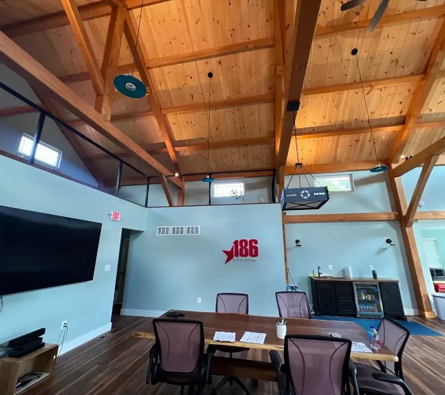 Exposed beam ceiling with wood accents and a meeting area below